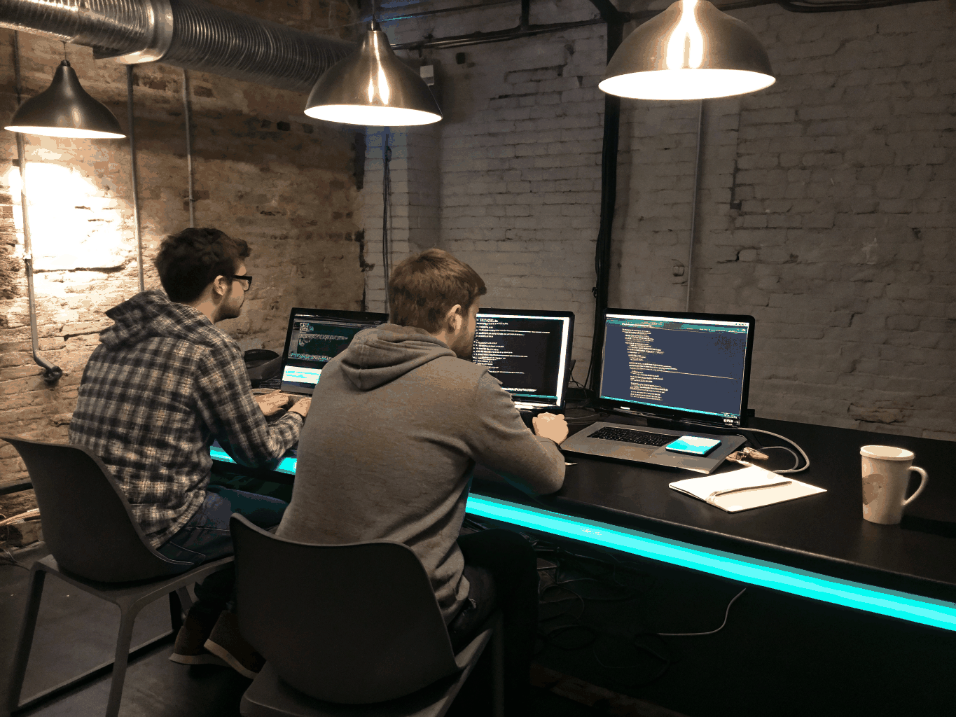 Developers collaborating at a hackathon in a modern tech workspace